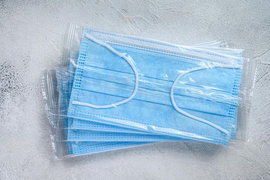 Blue ear loop surgical face masks. Disposable procedural face mask with malleable nose clip. White background. Top view