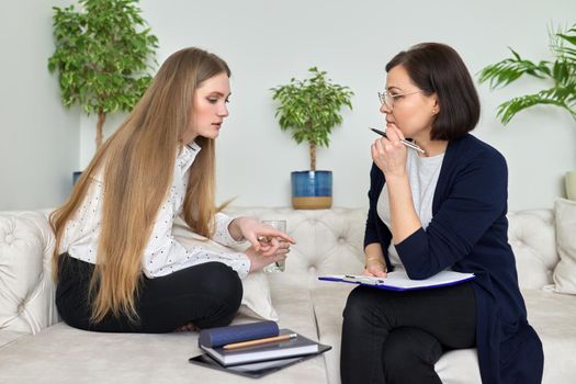 Meeting of young woman patient with psychologist