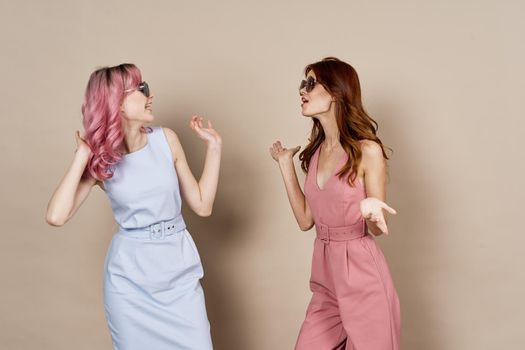 two girlfriends standing side by side posing fashion luxury