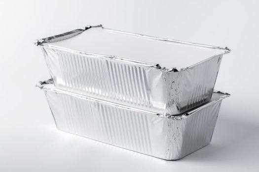 Foil food box with takeaway meal on white background