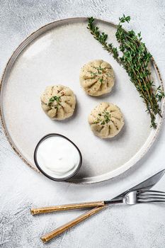 Asian Steamed Dumplings Manti with mince meat on a plate. White background. Top view