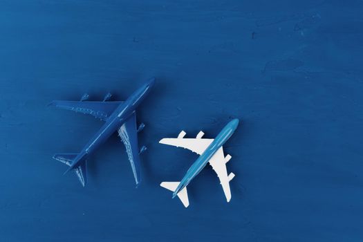 Toy plane on classic blue background, top view. High quality photo