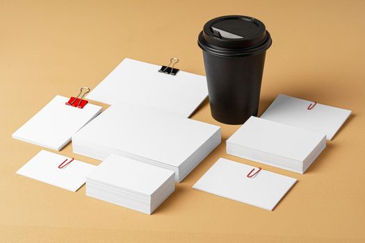 Blank takeaway coffee cup and white businesscards