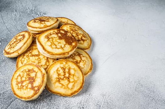 Stack of buttered pancakes on a kitchen table. White background. Top View. Copy space