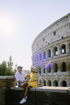 young couple mid age on a city trip in Rome Italy Europe, Colosseum Coliseum building in Rome, Italy