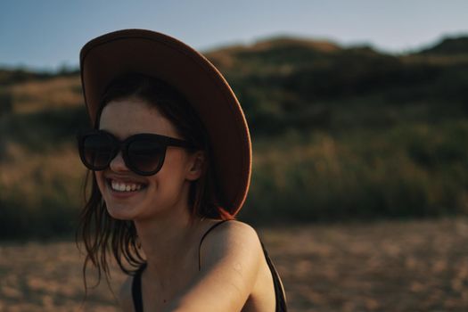 woman in sunglasses near car travel summer vacation landscape. High quality photo