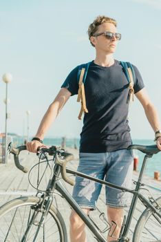 Cyclist standing on the pier.
