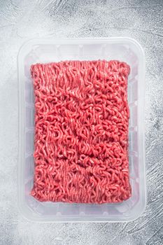 Fresh Raw mince beef and pork meat in vacuum packaging. White background. Top view