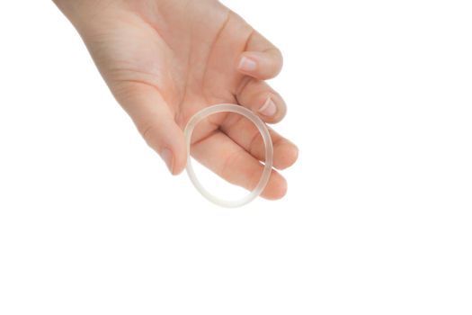 Birth control ,hormone, contraception ring in a womans hand isolated on white background, vaginal ring for contraceptive use with copy space