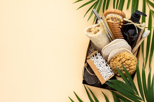Zero waste beauty body care items on color paper background. Wooden comb, bamboo toothbrushes, reusable cotton pads, soap without package, bamboo and metallic straws, bamboo ear sticks, hand made body lotion, luffa, bamboo massage brash and pumice stone.