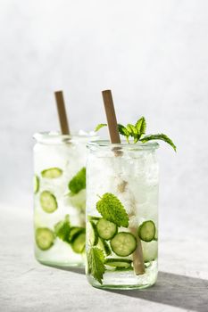 Delicious refreshing water with mint and cucumber with hard light and shadows