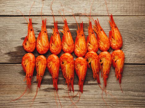 Boiled shrimps on wooden background