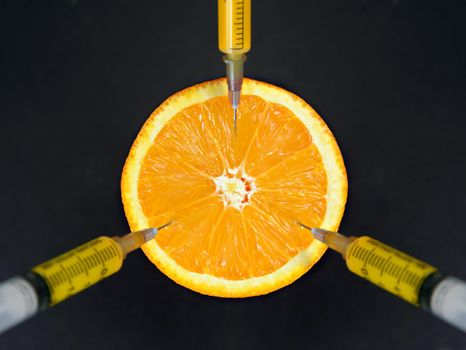 Orange with syringes
