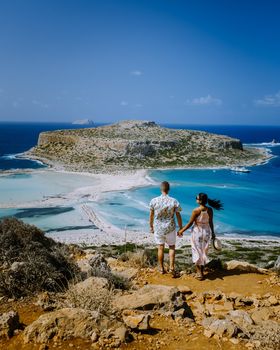 Crete Greece, Balos lagoon on Crete island, Greece. Tourists relax and bath in crystal clear water of Balos beach.