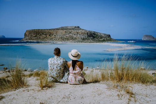 Crete Greece, Balos lagoon on Crete island, Greece. Tourists relax and bath in crystal clear water of Balos beach.