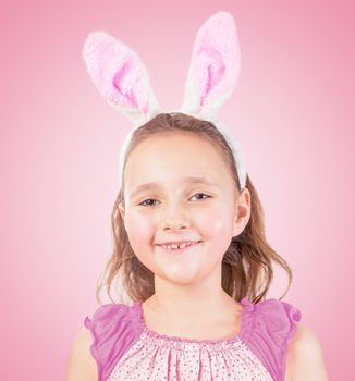 Little girl in Easter bunny ears smiles