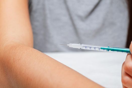 Teenager holds syringe