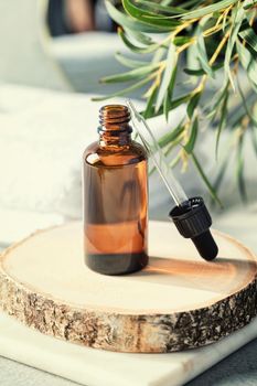 Amber glass bottle with eucalyptus leaves and towels. Natural organic cosmetic packaging, luxury beauty products for body care