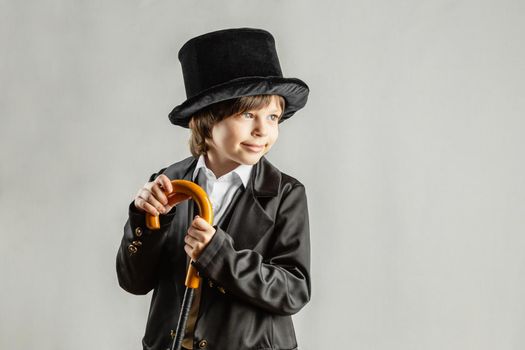 Young six year old boy wearing black suit
