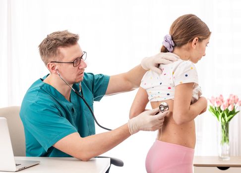 Doctor checking health status of a girl