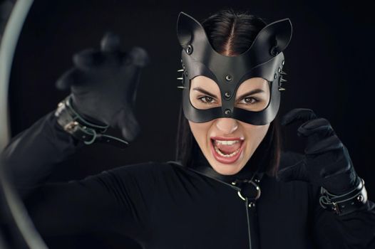 a woman in black belt and cat mask emotional portrait