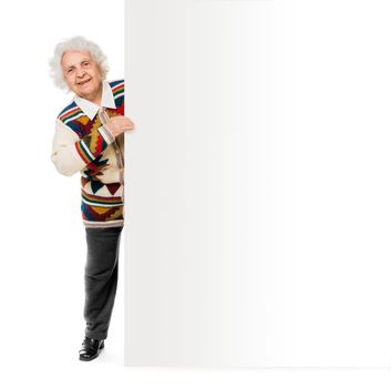 elderly woman alongside of ad board