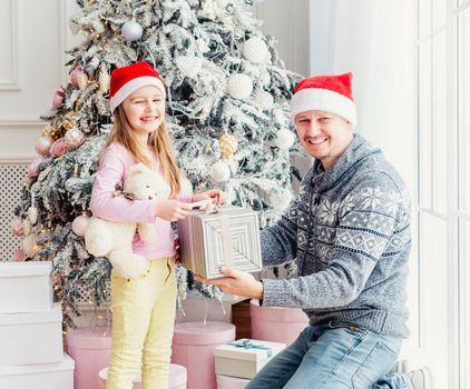 Father giving daughter christmas gift