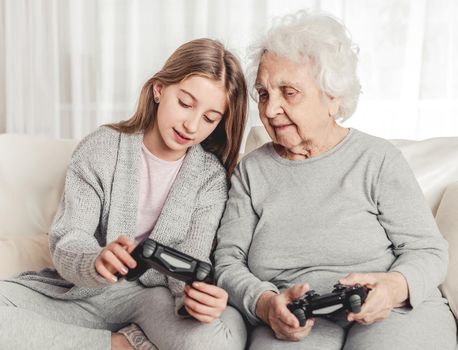Grandmother with granddaughter playing games