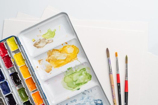 Stained paintbox with brushes
