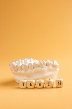 Close-up individual tooth tray Orthodontic dental theme. In hand Invisible braces