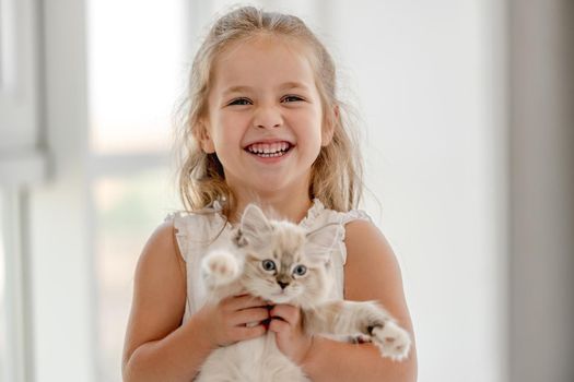 Girl with ragdoll kitten