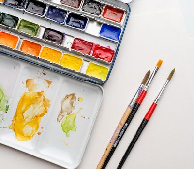 Stained paintbox with brushes