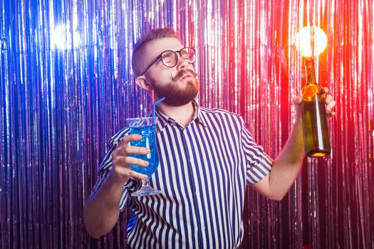 Alcoholism, fun and fool concept - Drunk crazy guy at party in a nightclub.