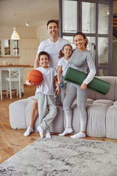 Cheerful active family doing sport at home