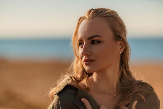 Profile portrait of a young beautiful blonde with loose hair on the beach.
