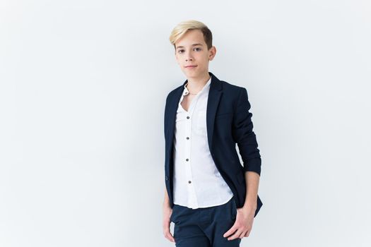 Puberty concept - Teenage boy portrait on a white background with copyspace.
