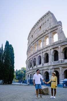 young couple mid age Asian woman and European man on a city trip in Rome Italy Europe, Colosseum Coliseum building in Rome, Italy