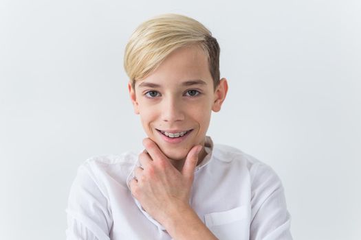 Attractive eleven year old boy with braces on his teeth. Dentistry and teenager concept.