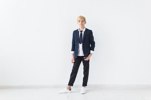 Puberty concept - Teenage boy portrait on a white background with copyspace.