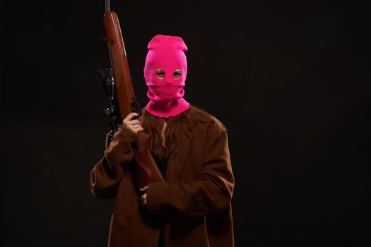 woman with gun in hand pink mask crime danger shooter