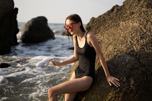 woman in black swimsuit rocks posing oceans