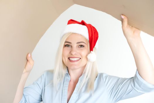 christmas, x-mas, winter, happiness concept - smiling woman in santa helper hat with parcel box