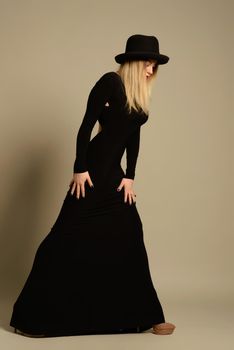 Fashion photo of beautiful lady in elegant black dress and hat