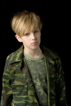 Confident teenage boy in camouflage clothin