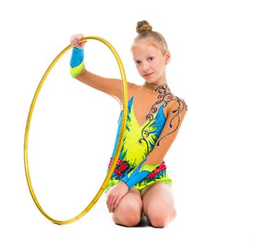 little gymnast sitting on the floor with hoop