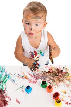 little boy painting with hands