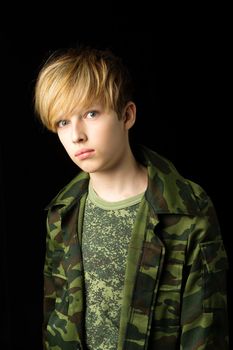 Confident teenage boy in camouflage clothin