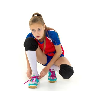 Girl crouching down and tying her shoelaces