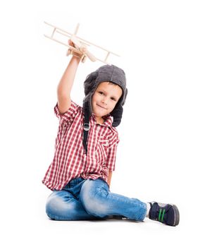 little boy with pilot hat and toy airplane