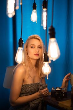 Portrait of a beautiful woman and vintage lamps. Woman looking at the camera